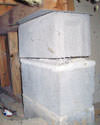 Concrete crawl space support posts in Elma that are showing signs of failure as they sink into the earth.