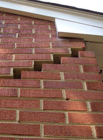photo of a rotating foundation wall with cracks in Arcade