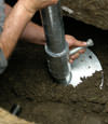 Tonawanda helical pier installation nearing completion, with the blade being advanced into the foundation soils.