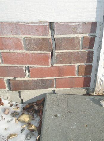 Severe street creep damage to a garage wall outside a Sanborn home