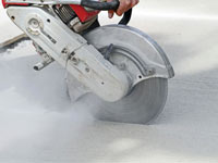 Cutting the driveway for expansion joints during street creep repair in Akron