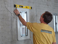 Positioning a wall plate cover on a foundation wall in Orchard Park.