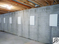 Wall anchor covers installed along a foundation wall that has been straightened in Clarence Center.