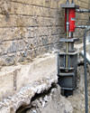 A completed installation of foundation push piers lifting a foundation in Akron