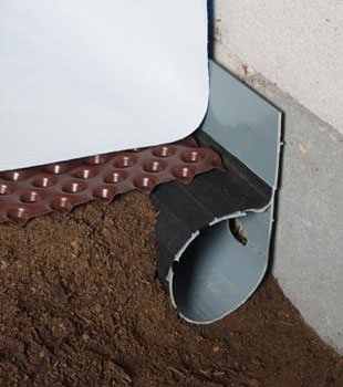 Closeup of a crawl space drainage system installed in Newfane