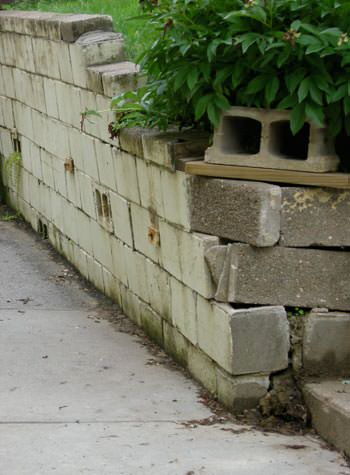 collapsing retaining wall with severe damage in Clarence