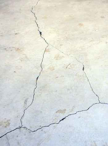 severely cracked, heaving slab floors in a home in Springville