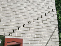 Stair-step cracks showing in a home foundation in Eden