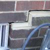 A closeup of a failed tuckpointing job where the brick cracked on a Cheektowaga, West Seneca, Dunkirk home.