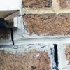 Failed crack repair showing old tuckpointing that cracked on a Rochester home.