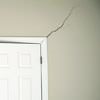 A long drywall crack beginning at the corner of a doorway in a Akron home.