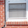 A gap in a window along the outer wall due to foundation settlement of a East Amherst home.