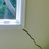 A long, diagonal crack that begins at a window corner of a Getzville home