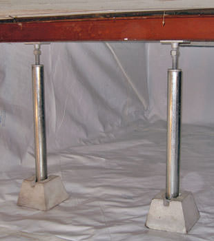 Crawl space jack posts installed in conjunction with a crawl space vapor barrier in Newfane