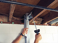 Straightening a foundation wall with the PowerBrace™ i-beam system in a Penfield home.