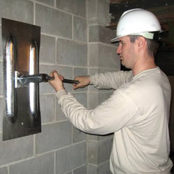 installing a wall anchor to repair an bowing foundation wall in Penfield