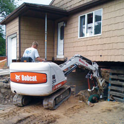 Excavating to expose the foundation walls and footings for a replacement job in Depew