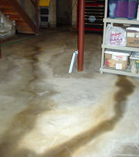 Flooding entering a basement through a floor crack in Akron