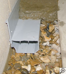 A no-clog basement french drain system installed in Lancaster